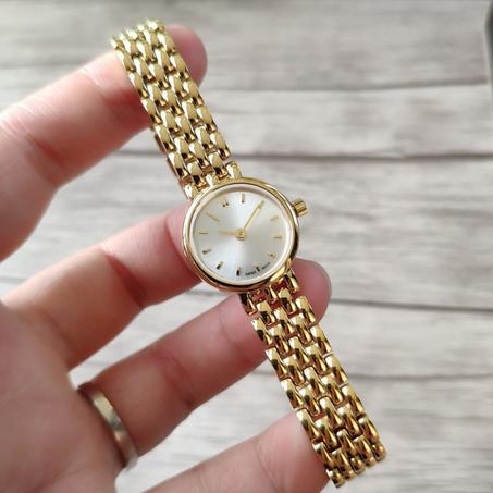 ساعة نسائية صغيرة أنيقة – باللون الذهبي وقرص أبيض ناعم
