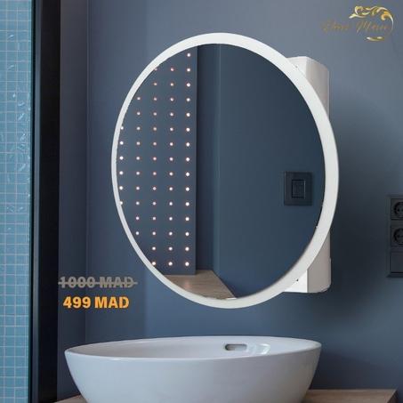 مرآة دائرية مع خزانة