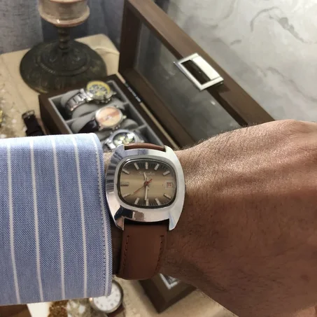 ⌚ Sorienter montre vintage arbore un boîtier chromé aux formes coussin/TV caractéristiques des années 1970, associé à un cadran brun dégradé et un bracelet en cuir marron.