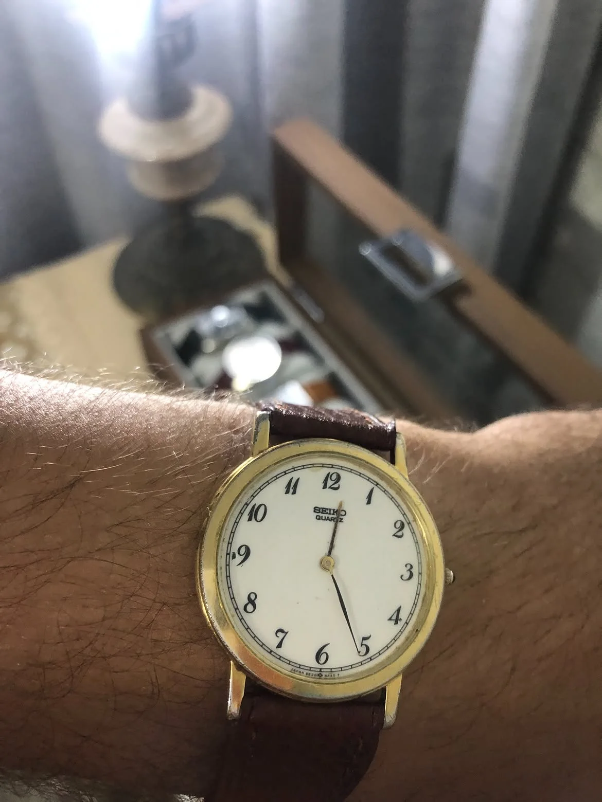 vintage Seiko Quartz ultra-thin dress watch. It features a classic round gold-plated case, an elegant white dial
