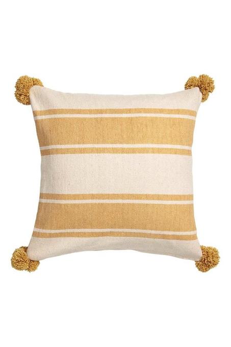 yellow and white cushion with pompom