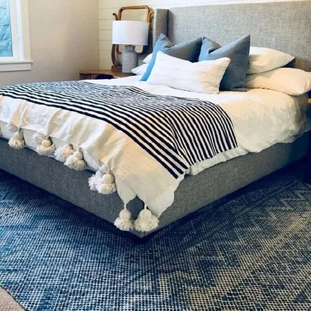 white and black blanket with white tassels