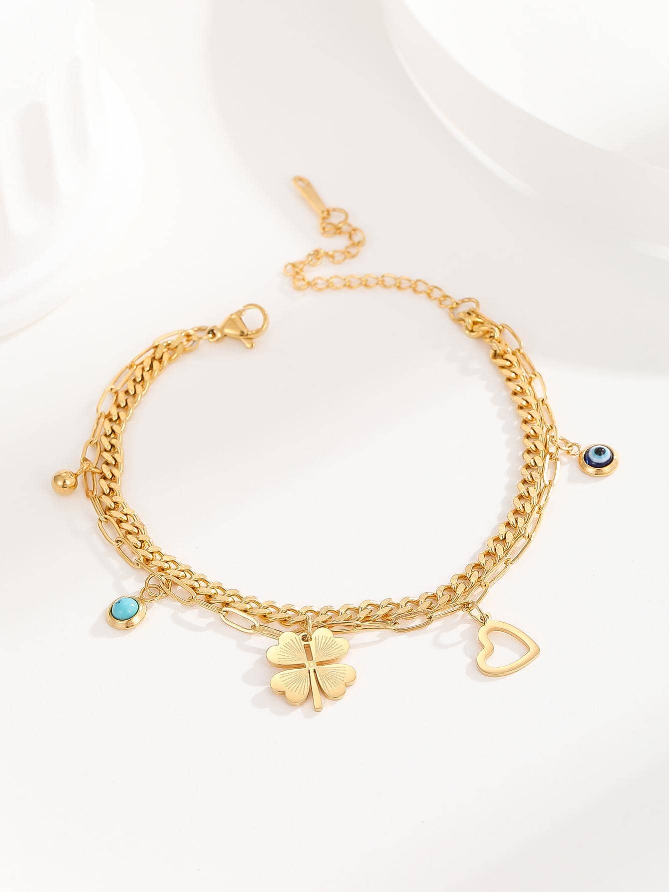 Bracelet à breloque trèfle et mauvais œil