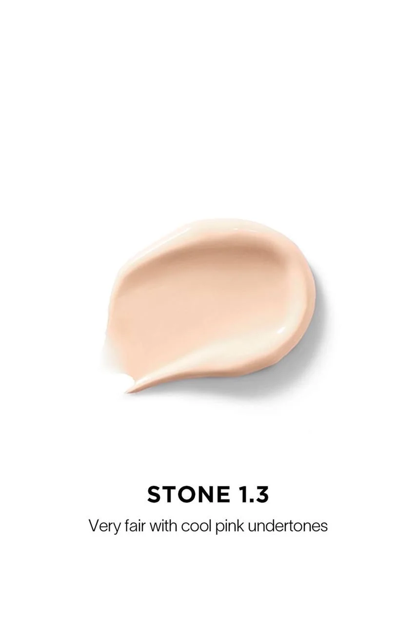 The Hourglass Vanish Airbrush Concealer features a distinctive metallic bronze cap with a slanted geometric design and a soft doe-foot applicator