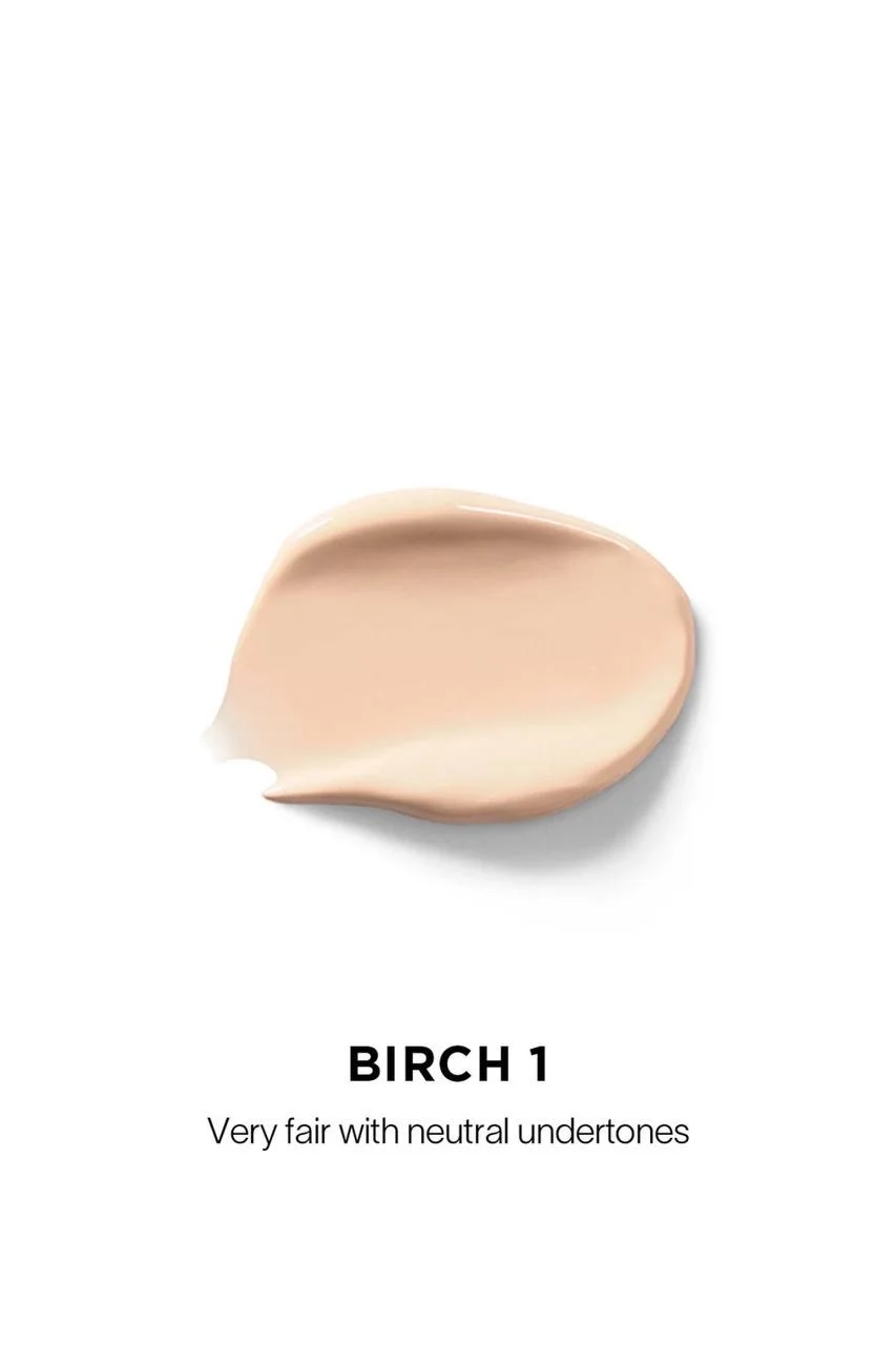The Hourglass Vanish Airbrush Concealer features a distinctive metallic bronze cap with a slanted geometric design and a soft doe-foot applicator