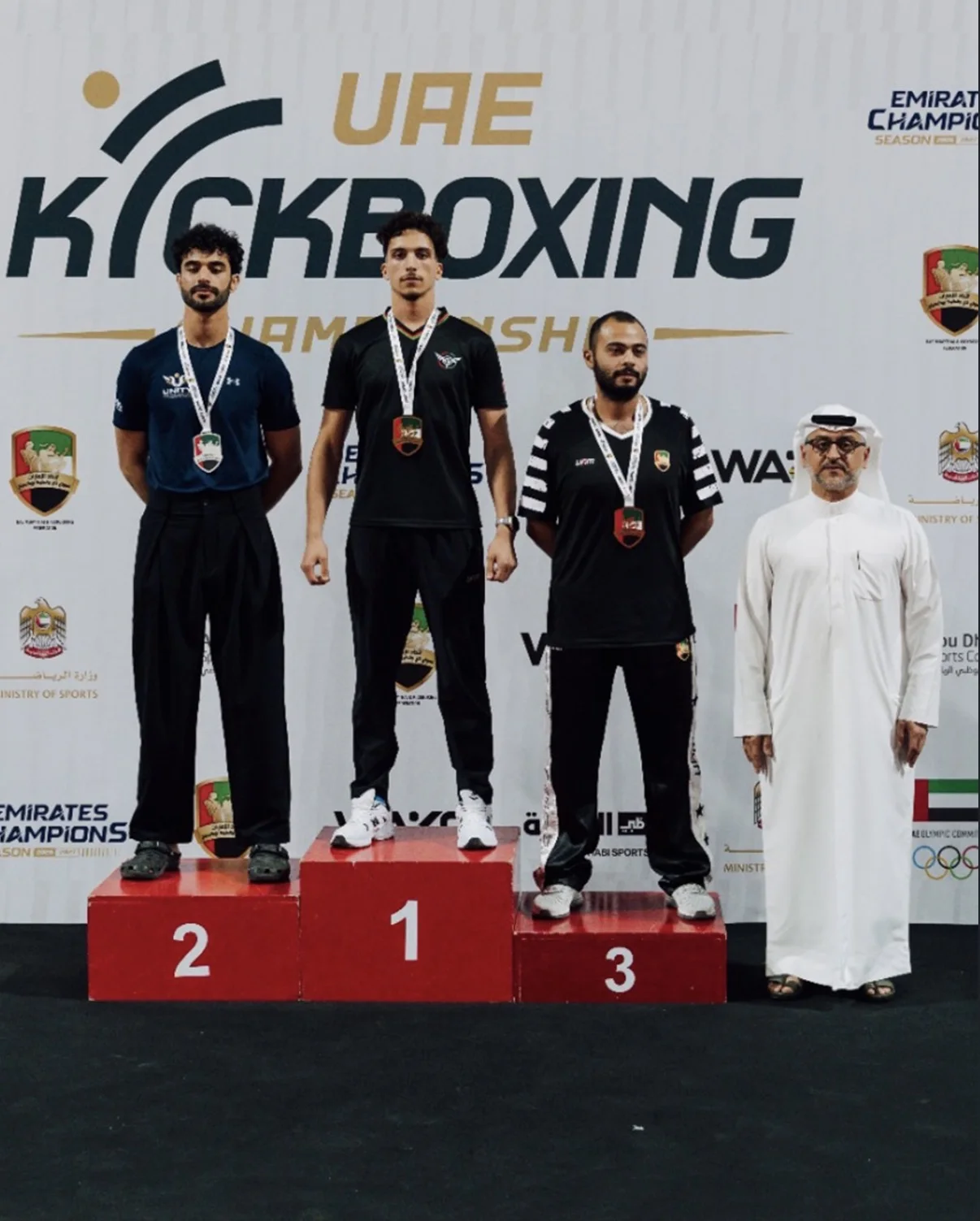 Coach Abdellah standing first on the UAE Kickboxing Championship podium