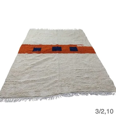 3- A Moroccan Berber rug in two colors, white and orange.