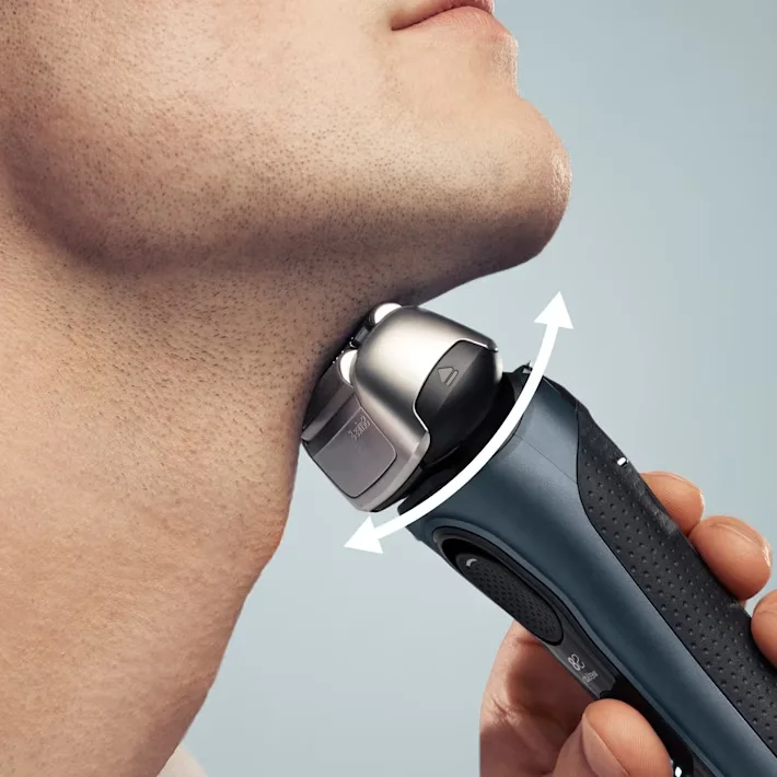 رجل يستخدم ماكينة الحلاقة على الذقن مع رأس دوّار رجل يستخدم ماكينة الحلاقة على الذقن مع رأس دوّار